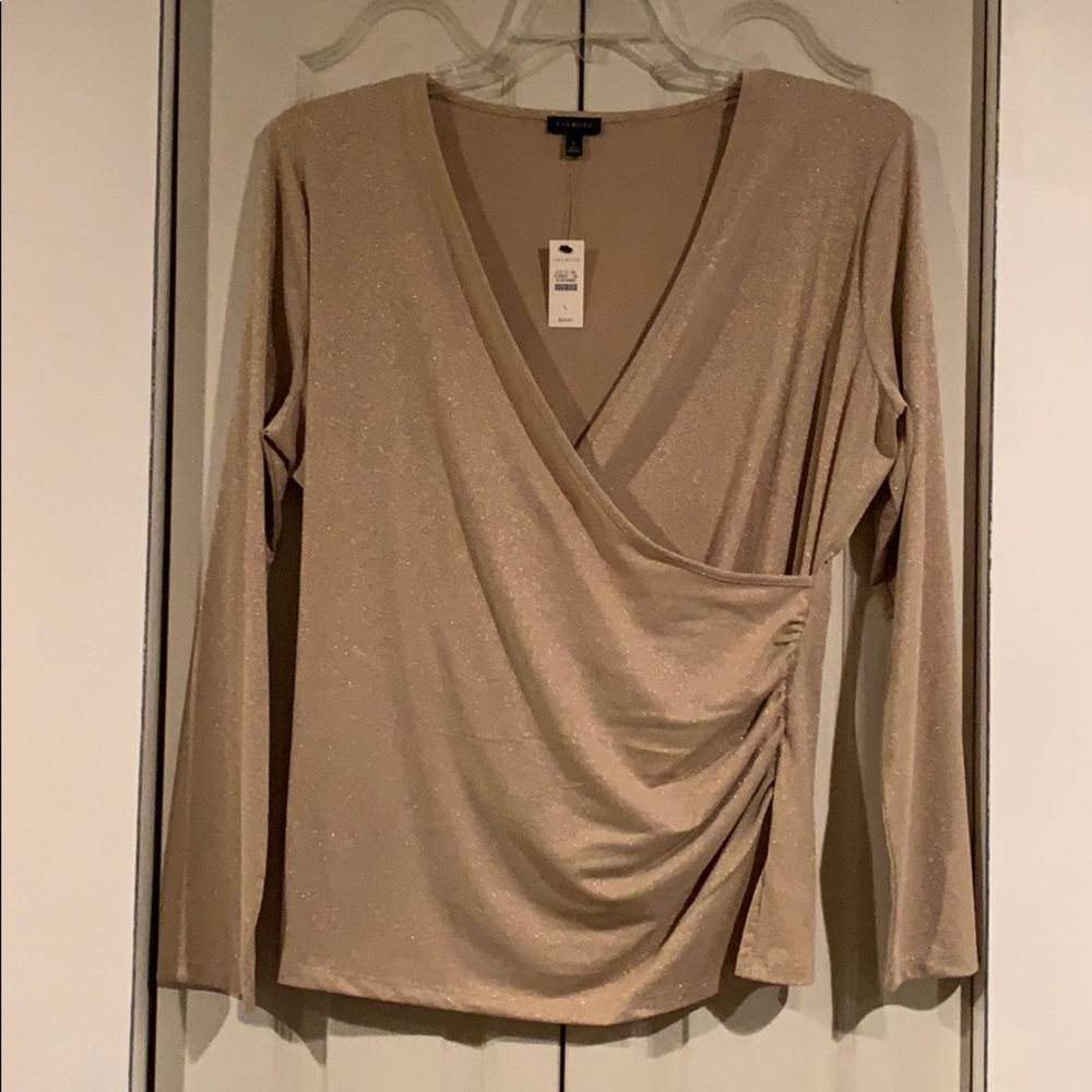 Women’s long sleeve metallic gold blouse.